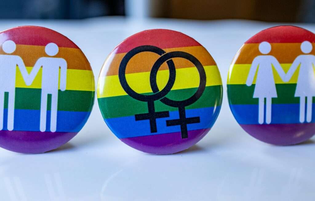 A group of three buttons with a male and female symbol on them